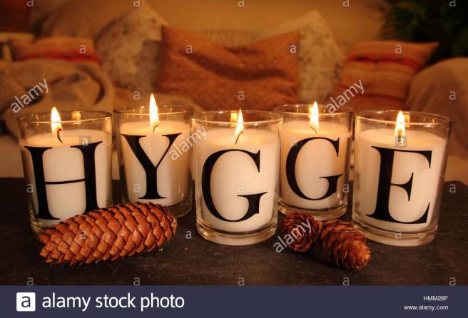 a-cosy-corner-in-an-english-living-room-lit-by-candles-that-depict-HMM28F